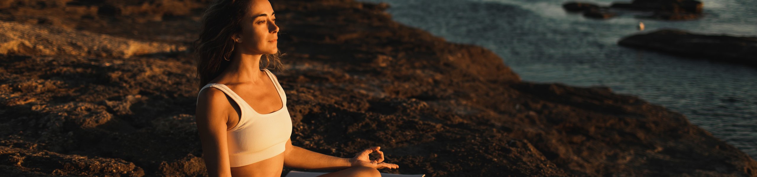 Woman doing yoga on the beach